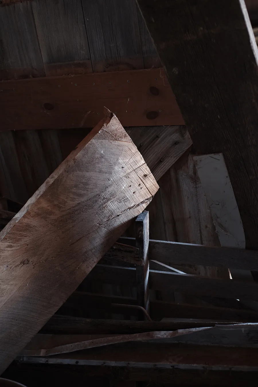 Boards catching light from the open barn door.